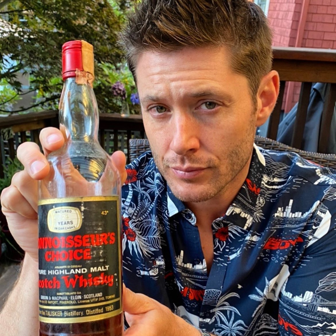 jensen ackles and holding things up for the camera