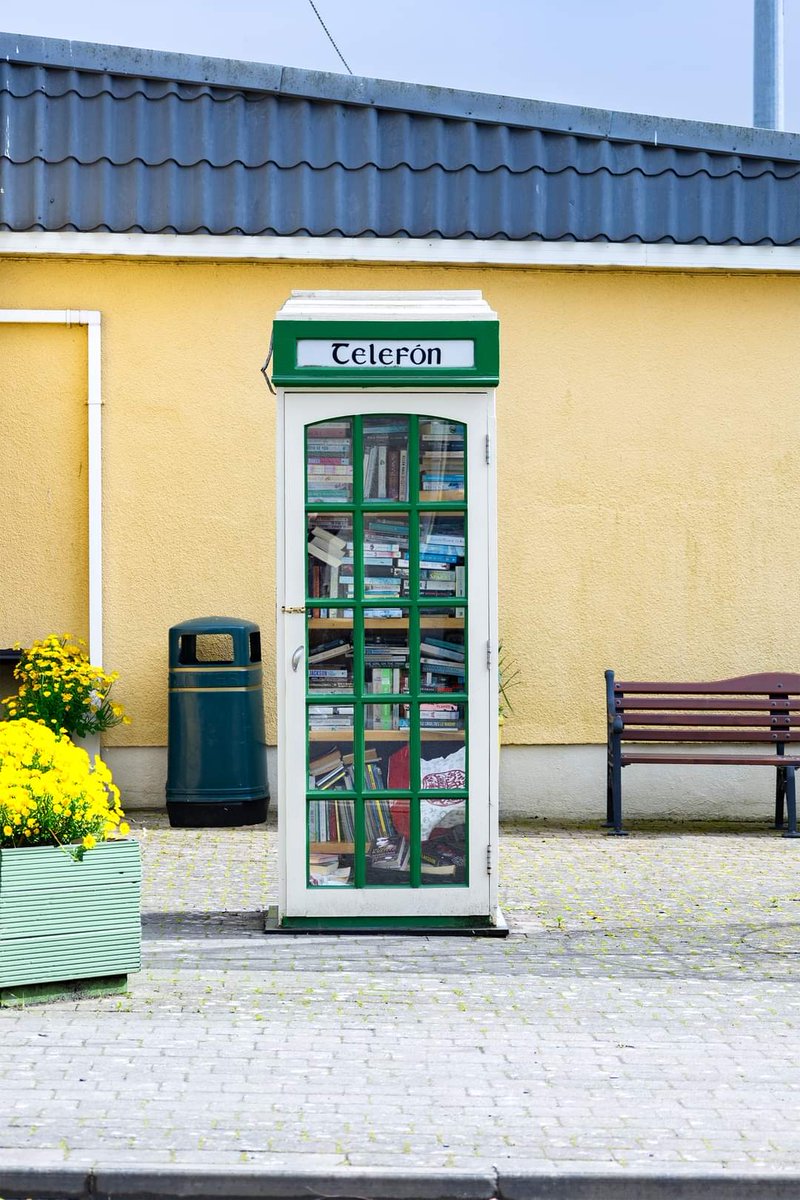 An authentic old telephone box on the Main Street in Camolin, operating as a mini-library - At their peak, there were around 3,300 payphone boxes across the country. When in the village, passers by can grab a coffee, have a perch, and find something interesting to read.