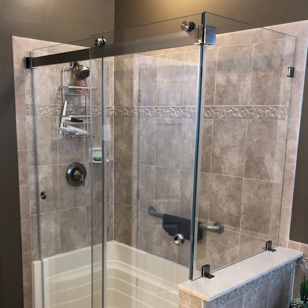 We installed this frameless sliding glass shower for a client! It's such a modern touch to this bathroom. We highly recommend it for anyone looking to upgrade their shower! #glass #customshower #shower #framelessshower #slidingglass #bathroomdecor #showerdesign #interiordesign