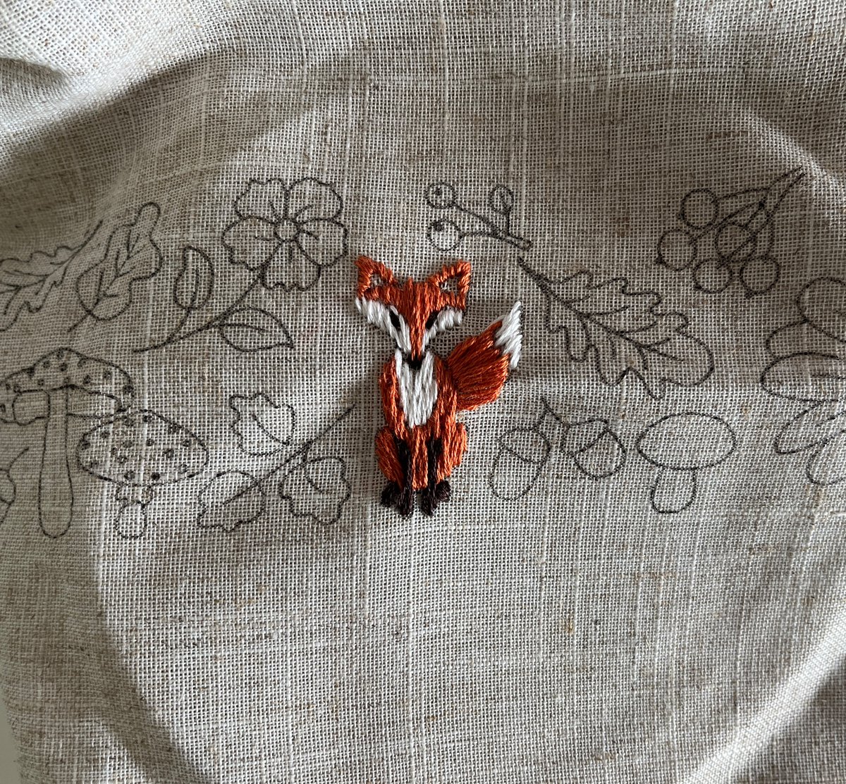 Just a fierce little embroidered fox staring back at you between the lines