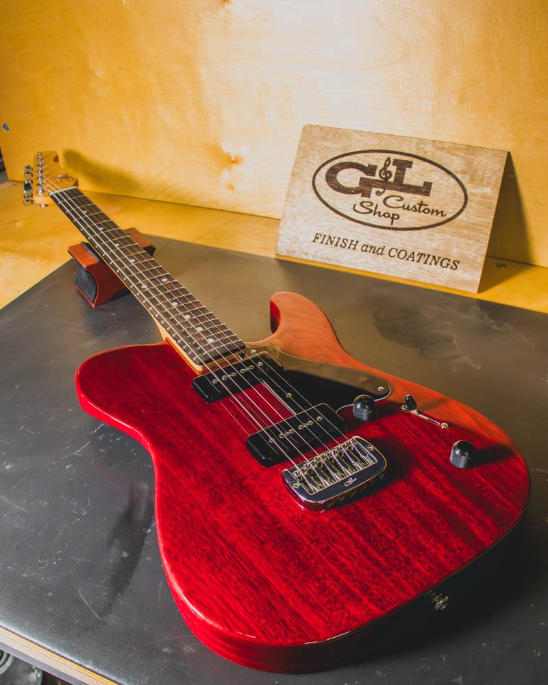 G&L Custom Shop ASAT HH RMC in Clear Red over Mahogany, P90s, 3-ply black guard, rear contour, quartersawn maple neck with rosewood fingerboard, Dark Toffee Satin finish, white pearl face dots, model logo delete. Built for G&L Premier Dealer UpFront Guitars.