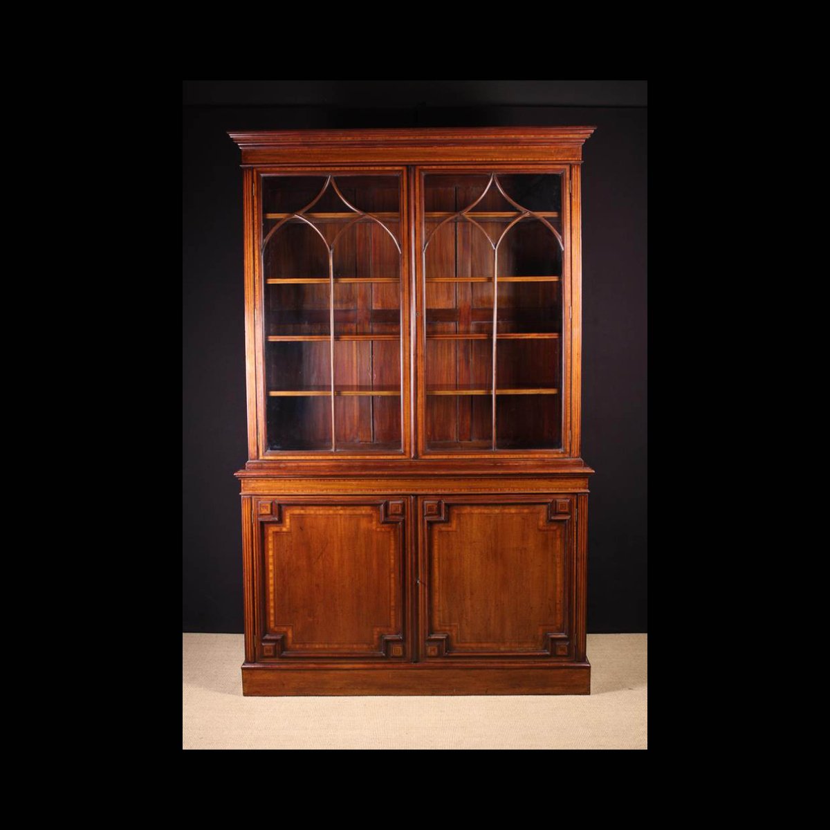 A Handsome Late 19th Century Inlaid Mahogany Bookcase inlaid with satinwood cross-banding edged with stringing. Lot 450. Viewing days Thurs 18th and Fri 19th 10-4pm. Viewing sale days 9-11am and by private app. #auction #onlineauction #auctionhouse #auctioneer #vintage