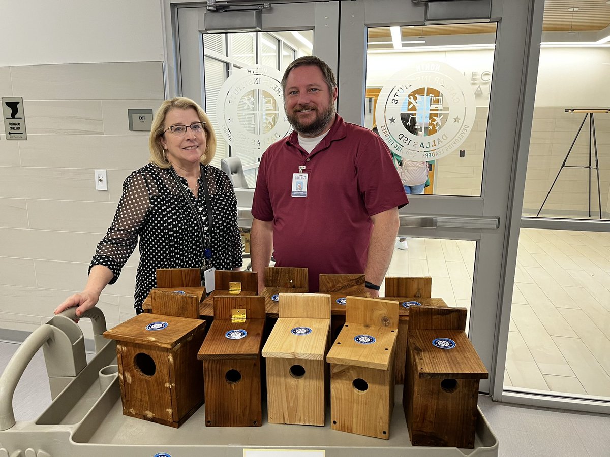 Mark Broughton, director of the Environment Education Center, was presented with the first batch of birdhouses by Jean Laswell, head of Career Institute North. Students in Mr. Harold Torres's Construction 1 class built these homes.