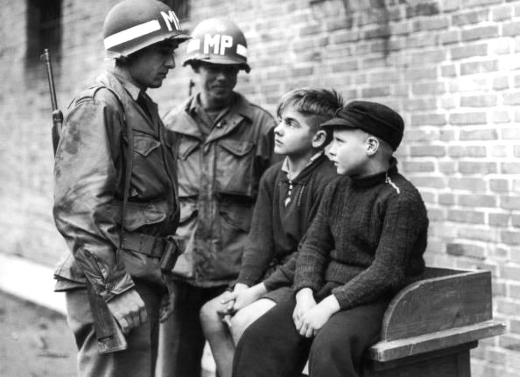 American MPs with two German boys, who are being held after shooting at U.S. troops in Aachen, Germany, in October, 1944. #History #WWII