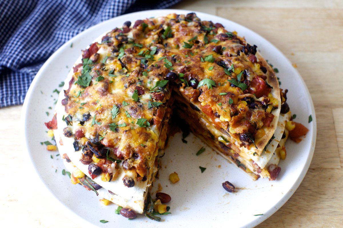 I don't make the rules, but trust me when I say that vegetables, beans, cheese and tortillas layered like lasagna and sliced like a cake are inexplicably more fun than other dinners on a weeknight.  smittenkitchen.com/2016/02/taco-t…