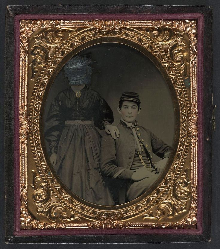 Tintype portrait of an unidentified soldier in Union uniform with an unidentified woman. The woman's face is scratched out. Photographed between 1861-65. Library of Congress.
