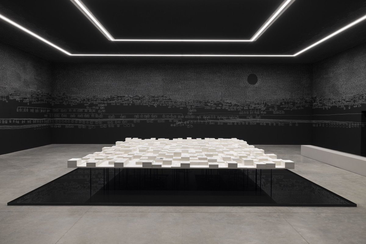 miaforrestphoto's tweet photo. To those heading to the Venice Biennale please take the time to check out the Australian Pavillion, where Archie Moore’s work is being presented, ‘𝐾𝑖𝑡ℎ 𝑎𝑛𝑑 𝐾𝑖𝑛’. 

Archie’s memorial installation comprises of a vast hand-drawn genealogical chart using fragile chalk, mapping his First Nations connections which span more than 2,400 generations and 65,000 years.

Moments of erasure amidst the names represent the atrocities inflicted upon first nations communities, such as massacres, the 
introduction of diseases and destruction of knowledge, that have all produced intergenerational trauma.

In using chalk - a symbol of educational material - he addresses the insufficient dissemination of First Nations histories.

More than 500 document stacks containing 
mainly coronial inquests on the deaths of indigenous australians in police custody, dated in our lifetime. despite first nations australians being just 3.8% of australia’s population, they account for 33% of its prison population, making  them among the most incarcerated people globally. Surrounded by the 
limitless family tree, viewers are reminded that the reports do not represent nameless statistics; rather, they are children, siblings, cousins, parents, uncles, aunts, grandparents and great-grandparents.