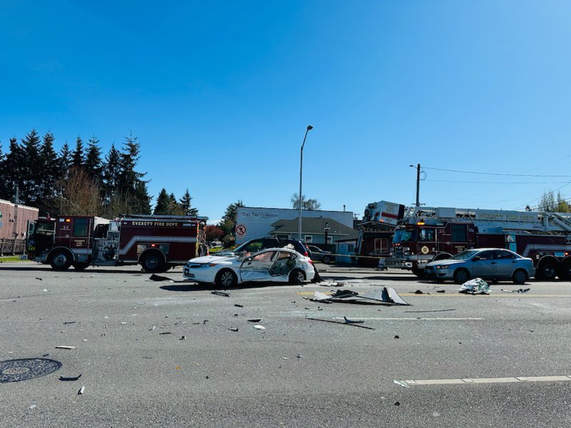 Multiple vehicles involved in the collision, including a delivery truck, box truck, & a passenger car. One occupant transported with serious injuries.