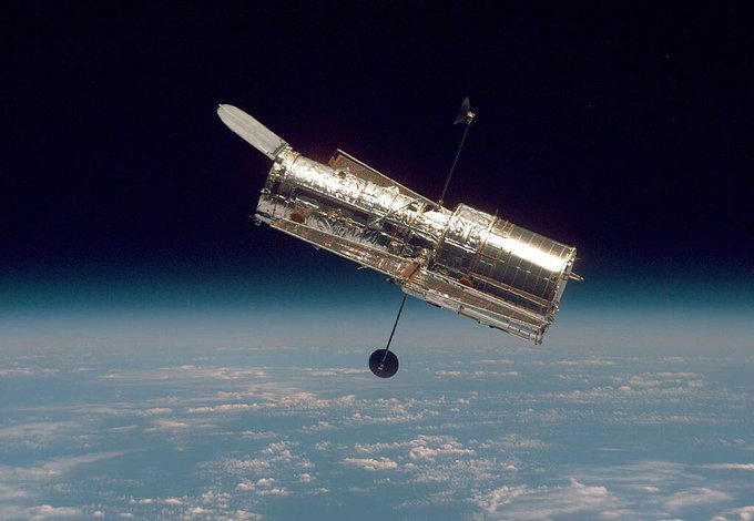 A photo of the Hubble Space Telescope above earth