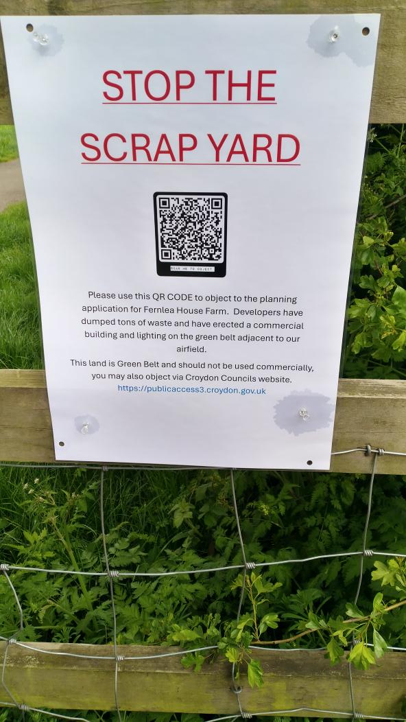 A retrospective planning application for a large building put up without consent near the airfield. Scan QR code to object.