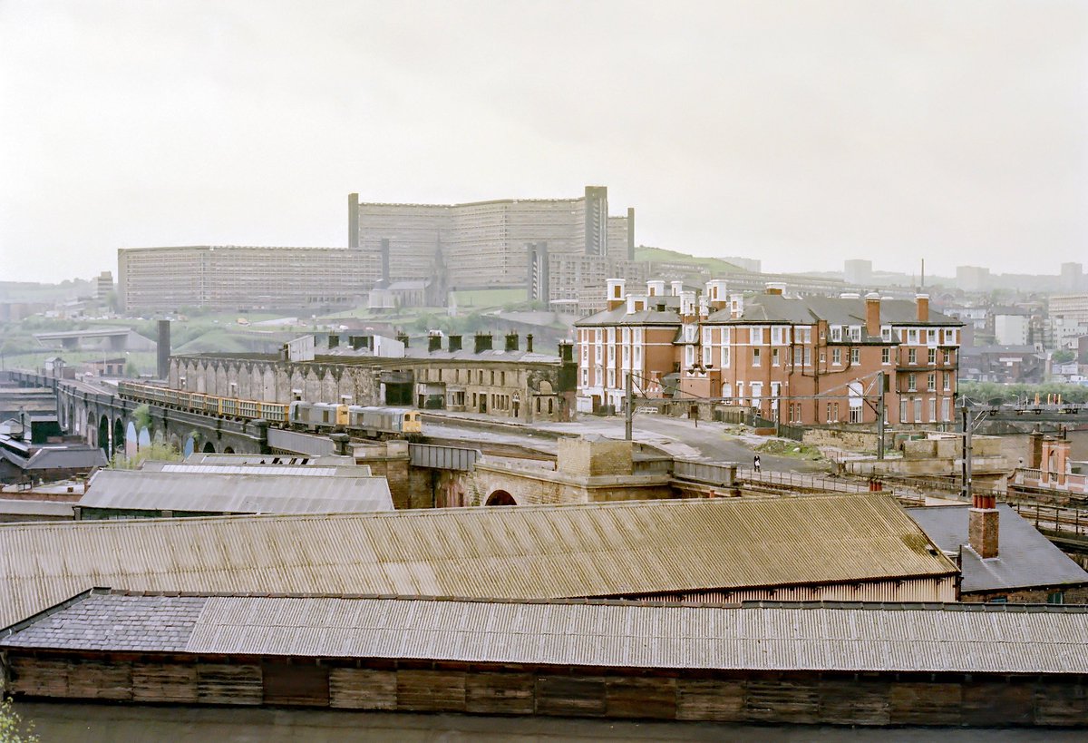 2x Class 20s pass through the empty shell of Sheffield Victoria station enroute to the Stockbridge steelworks in May 1986. Today the site of Sheffield Victoria station is now a car park for the hotel. © Andrew Stringfellow