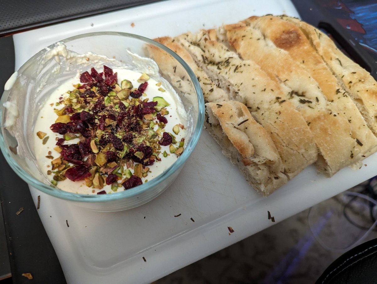 Whipped feta and Greek yogurt dip with cranberries and pistachios. Rosemary garlic focaccia to soak it all up with. 🤤