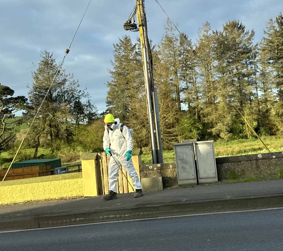 What a bizarre sight in Kilmeaden. The chemicals are so toxic a full on protective suit is needed. Who cares about the person passing by walking their dog or the children getting their bus to school? All to kill some moss & wildflowers. Hope it doesn’t get into the water! 1/