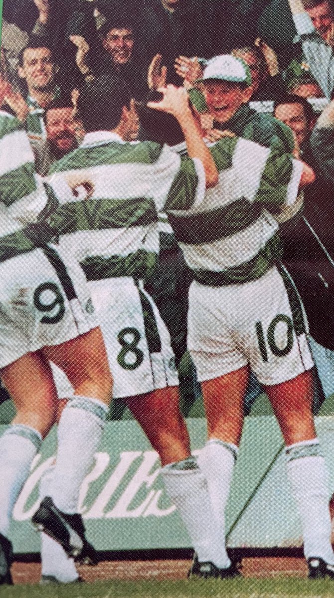 Charlie Nicholas celebrates with a ball boy after scoring for Celtic