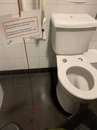 PLEASE stop tying up Red emergency cords in accessible toilets & if you see one tidied up, please untie it It should hang all the way to the floor - & it can be vitally important for the health & safety of disabled folk 1st pic is what NOT to do, 2nd pic is what to do