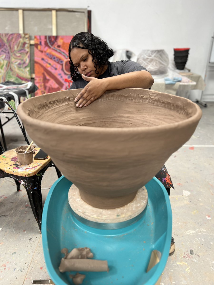 Le Shaye Swan, hard at work making the right size tea cup ☕️ for the desert queens 👑 in our studio. 😆 Le Shaye’s commitment to her practice and drive has been an inspiration to all of us at the APYACC this year. 🖤💛❤️ #aboriginalart #aboriginalbusiness #ourartourbusiness