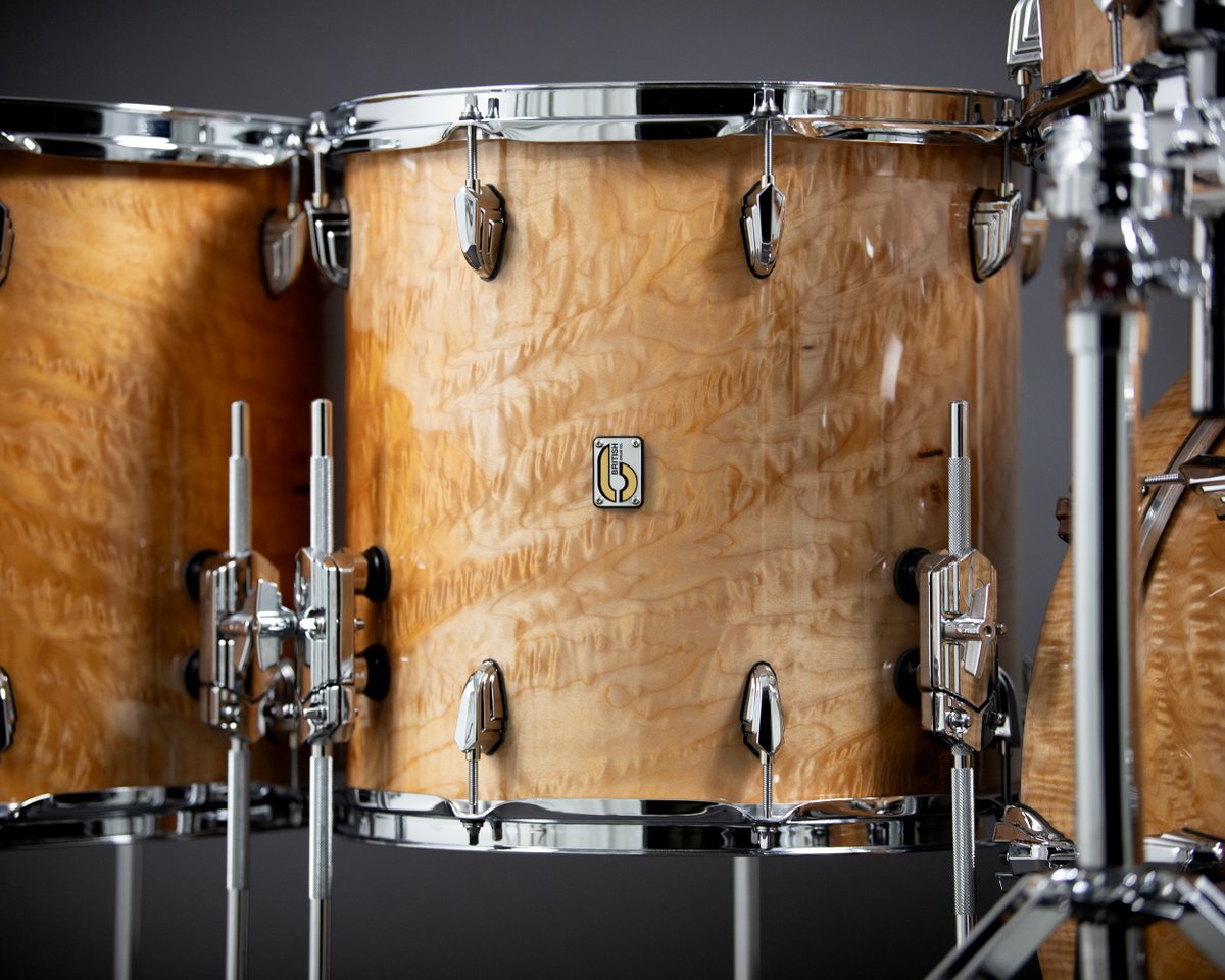 Crafted from rich mahogany with quilted maple veneer, exuding sophistication. Finished with a lustrous gloss, igniting every drummer's passion. Let the rhythm take over, available from @grdrums. Sizes: 10”x8”RT • 12”x8”RT • 14”x14”FT • 16”x14”FT • 22”x16”BD