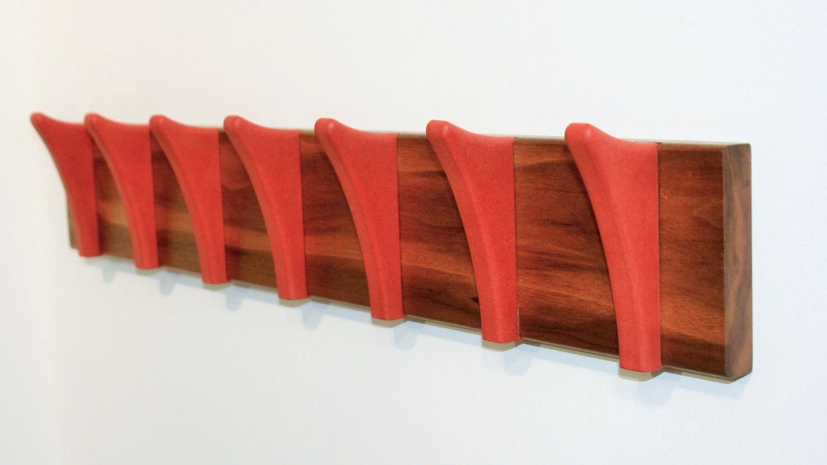 Why hang your coat on something mundane when you could have this beautifully handcrafted coat rack adorning your wall? Made from Walnut and Valchromat in a vibrant red wood, it is engineered for strength, moisture resistance and made to last a lifetime.