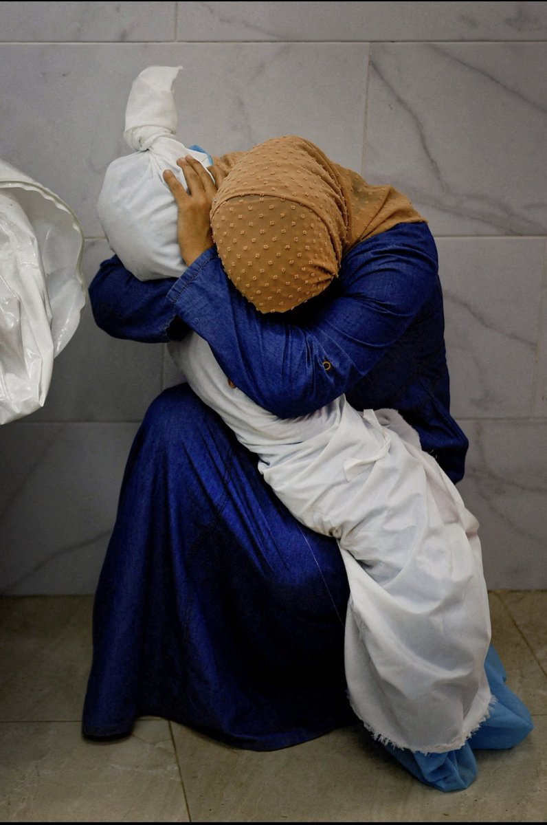 World Press Photo of the Year. Inas Abu Maamar (36) cradles the body of her niece Saly (5) in Khan Younis. The child, her mother and her sister were killed when an Israeli missile struck their home. By Mohammed Salem of Reuters.