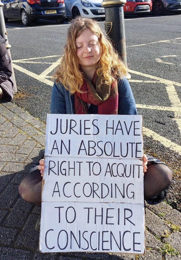 Trudi Warner could face two years in prison simply for holding a placard outside a court stating a right which is written in stone on The Old Bailey. Today outside Truro Court, we did the same. We say: prosecute us too. #IStandWithTrudi