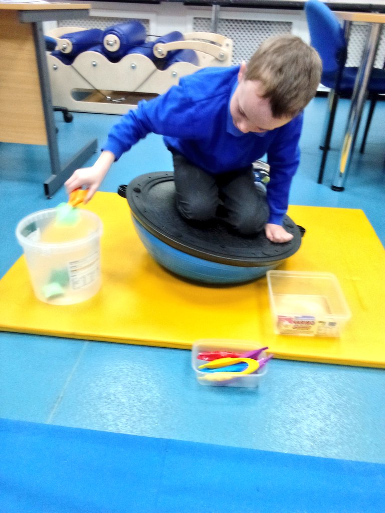 This week's balance activity using an overturned bosu ball. Maintaining balance whilst transferring small beanbags from one container to another with tweezers! Works the core, addresses midline crossing, hand strength and hand eye coordination! <a href="/Topcliffeschool/">Topcliffe Primary</a> #OTchampion