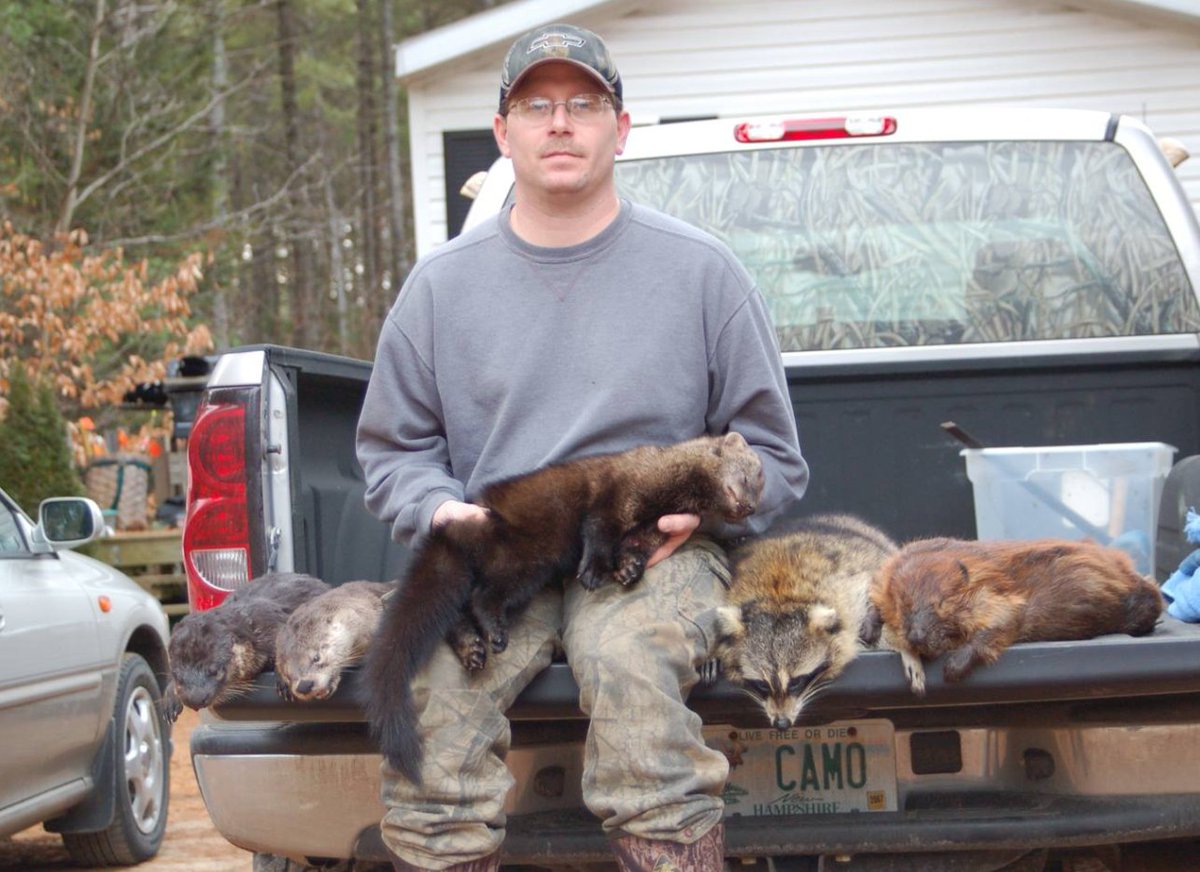 NHCART's tweet photo. Why do trappers enjoy torturing and killing animals so much? This NH trapper shows off his array of animals he trapped, including a #fisher he is holding. Fishers are declining in NH. Trappers have no respect for wildlife. #NHCART #BanTrapping #Coexist https://t.co/kHW0In0YA2