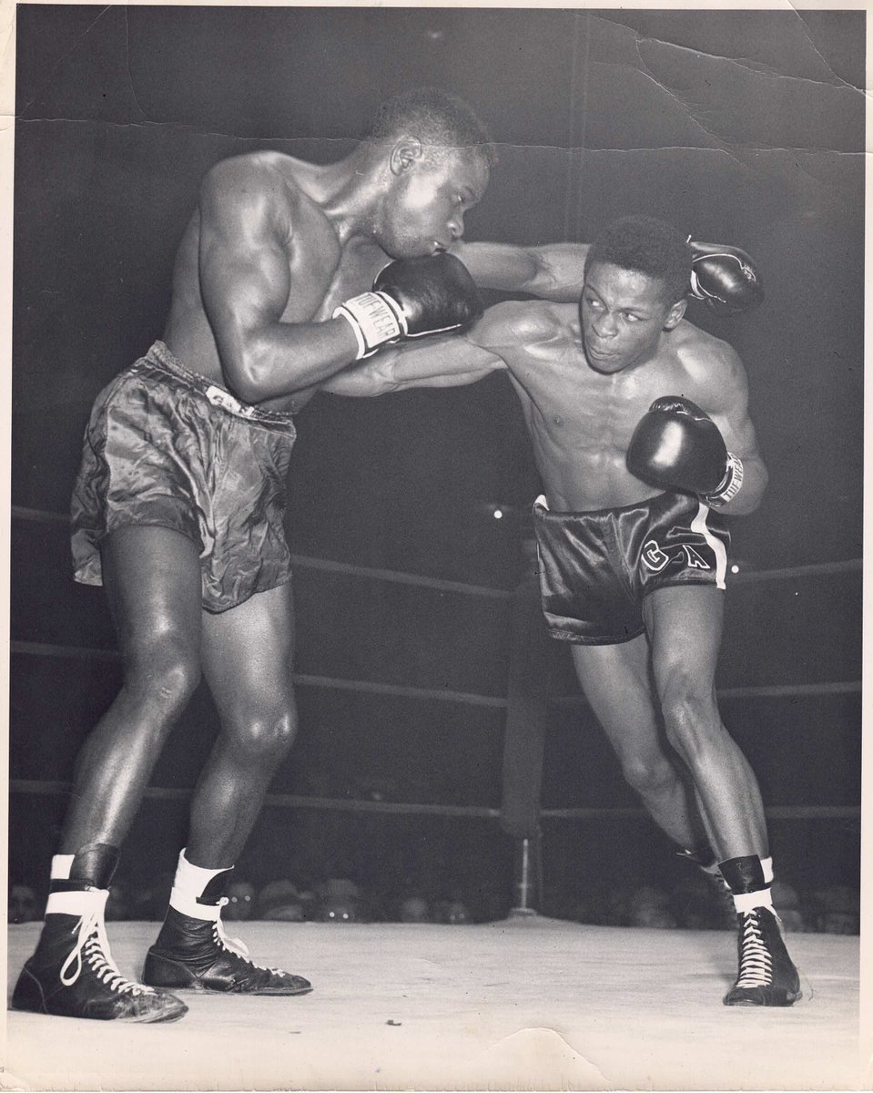 blackheritageRI's tweet photo. "George Araujo (1931-1997), pictured fighting Eddie Posey, was a Cape Verdean-American boxer from Fox Point, Providence. He fought Jimmy Carter for the world lightweight title in 1953 and retired in 1958 with a record of 58-9-1 with 33 KOs."
 #RIBHS #BlackTwitter  #blackhistory https://t.co/QmmMp5rDLO