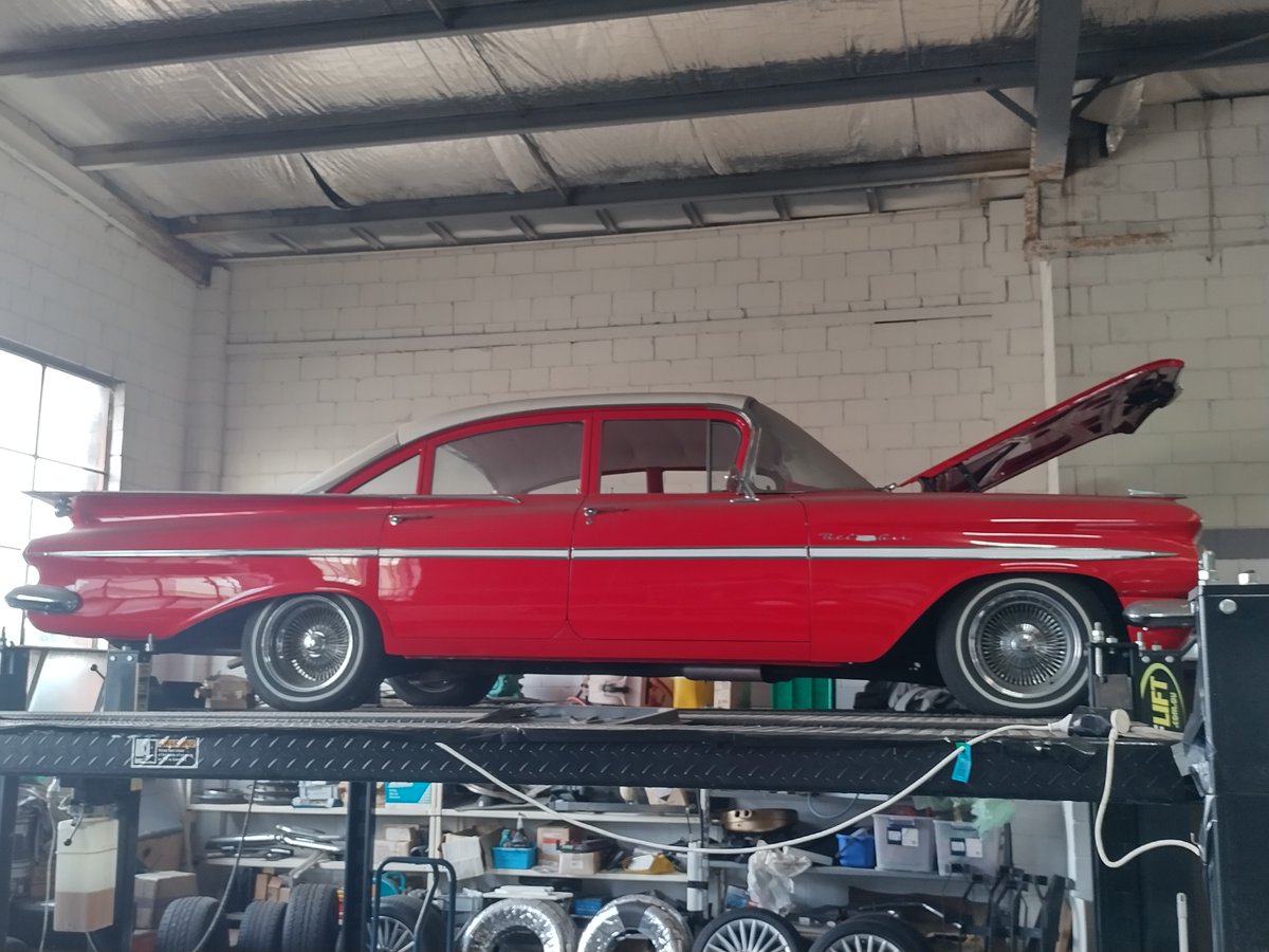 Check out this 59 Chevy Impala. It belongs to one of my friends. I'd often get a lift to school in this beast when I was young. It was hot pink back then, but it's now been fully restored to mint condition.