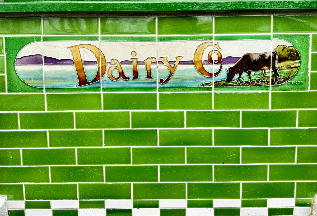 Old shopfront displays Buttercup Dairy's charming 1930s/40s ceramic tiles. Signed JD LTD for James Duncan who created ceramic tiles for nearly a century in Glasgow. Edinburgh artist Tom Curr (1887-1958) did the designs.