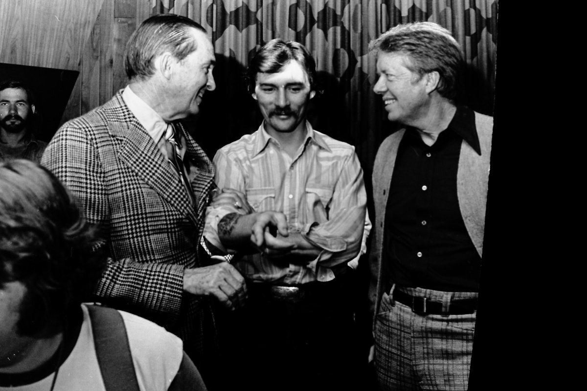 We send our condolences to the family of Dickey Betts, co-founder of the Allman Brothers Band. President Carter loved their music, and the band campaigned on his behalf. Betts is pictured here with Carter & publisher Don Carter at Capricorn Records.
 
Photo Credit: Herb Kossover