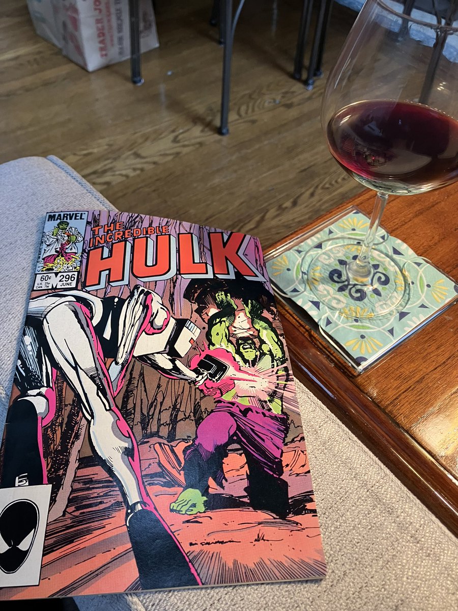 A comic book and a glass of red. Hulk from 1984 with Rom kinda showing his ass. Now reading