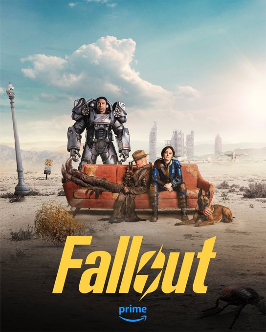Ella Purnell as Lucy, Aaron Moten as Maximus and Walton Goggins as The Ghoul from the Fallout TV series. Lucy and Ghoul are sitting on a beat up couch in the middle of the Wasteland, while Maximus stands behind them in the Power Armor suit. Behind them is the Los Angeles skyline, or what remains of it. Sitting beside them is CX-404, the bestest doggo, with a hand in mouth. The FALLOUT logo and Prime logo are at the bottom of the poster.