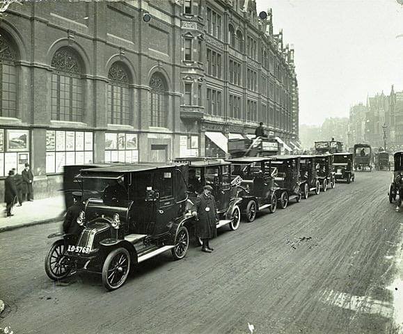 A Photograph of a Cab rank in Bishopsgate. Circa1912 London’s first black cabs in the 1890s were electric. Petrol powered vehicles appeared from 1903.