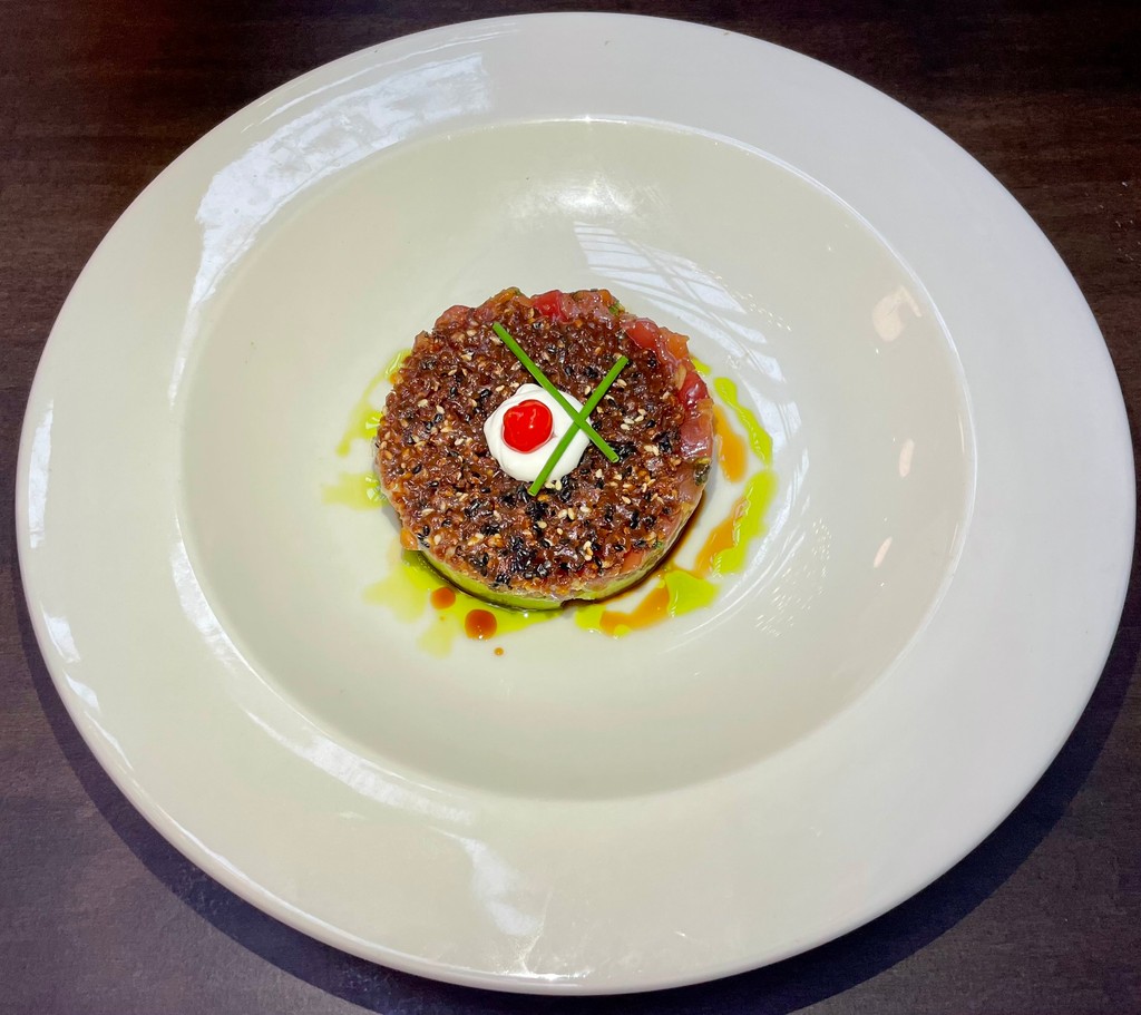The Ahi Tuna Tartare, made with tuna, avocado, shoyu, capers, preserved lemons, and olive oil and topped with a crunchy sesame seed tuile, is a must-try at Goodnight's Prime Steak House in Healdsburg, California. @Goodnights707 @UpscaleLivingMG #steakhouse #gourmetcuisine