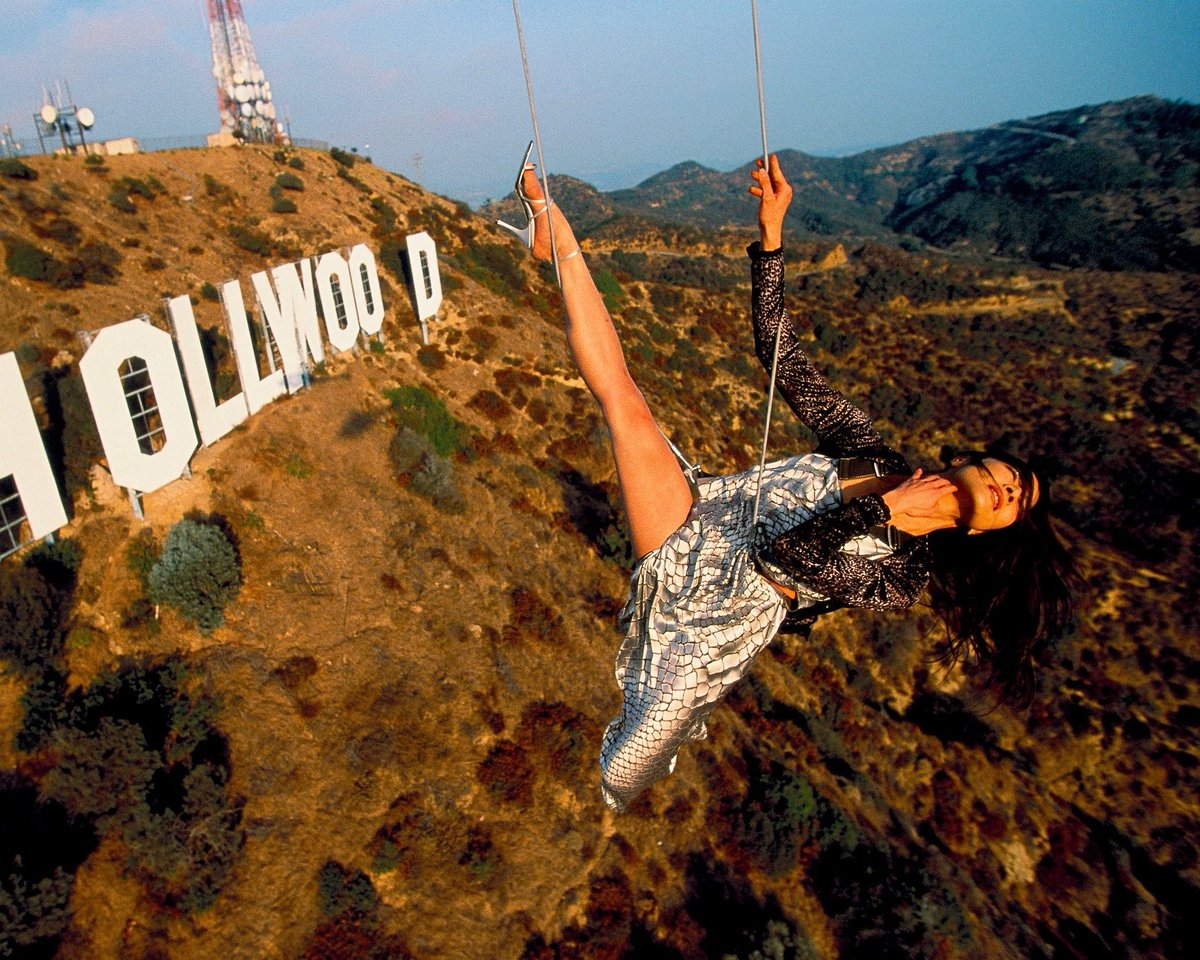 Michelle Yeoh doing a photoshoot in front of the Hollywood sign while hanging from a helicopter, 1998