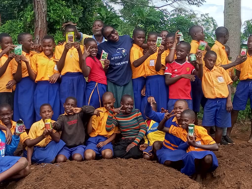 Pupils at St James Primary School, Buikwe district team up with Asiimwe, CorpsAfrica Volunteer, to set up vegetable gardens in their school for learning and nutrition purposes.#Thisiscorpsafrica. @CorpsAfrica