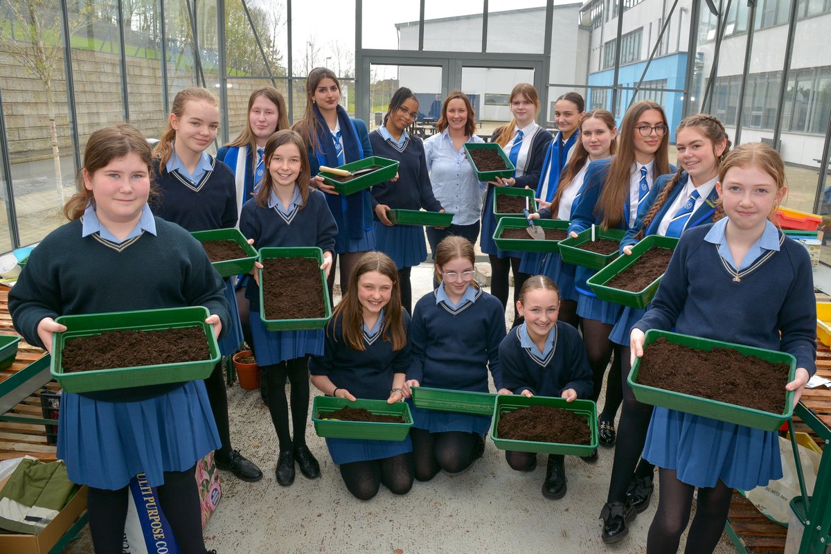 Eco Schools Committee members enjoying planting some seed trays with vegetables and flowers in our greenhouse. @Eco_SchoolsNI