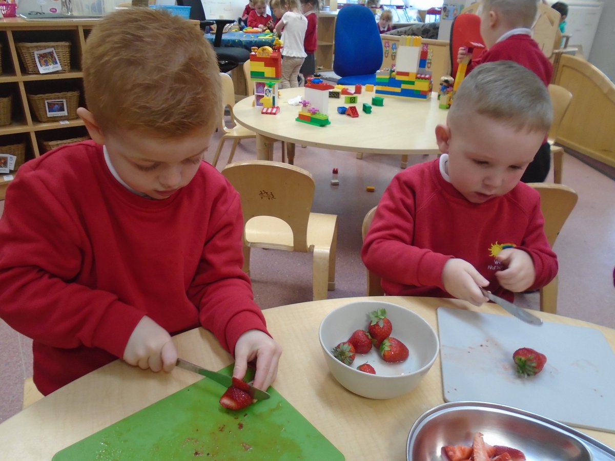 Nursery - At the snack table today we were practicing our cutting skills by cutting the strawberries in half for our morning snack. We then enjoyed them with some pancakes 🍓😀