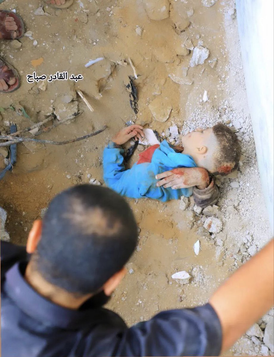 Here is an embrace where only an arm can be seen. Here is a hug beneath the rubble. He was seeking shelter with his brother’s arms.