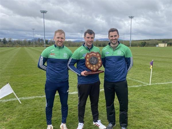 Captain Sean Rowley collecting the Senior “A” league title on a scoreline of 4-16 to 1-16 v St.Kierans College along with team photo and management photo 💚🤍