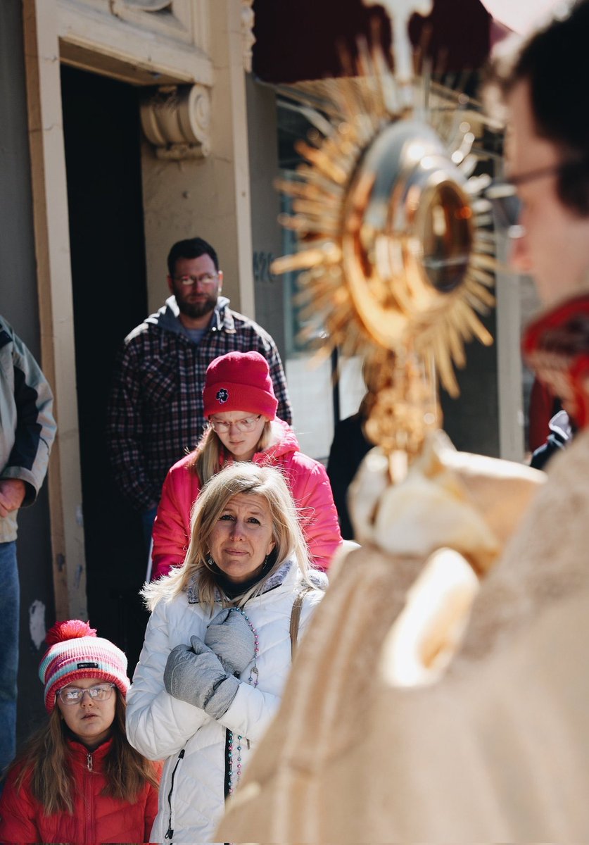 A woman’s emotional prayer during a priest's benediction of the Eucharist in front of an abortion clinic in Milwaukee. Image Credits: @ProLifeWI