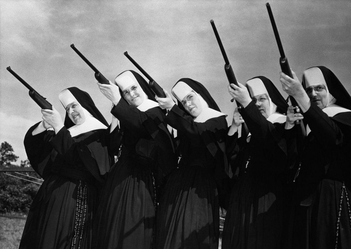 Sisters of Divine Providence trying out new .22 caliber guns presented to them at camp Mishannock by Harrington and Richardson of Worcester, Massacusetts. (1957)