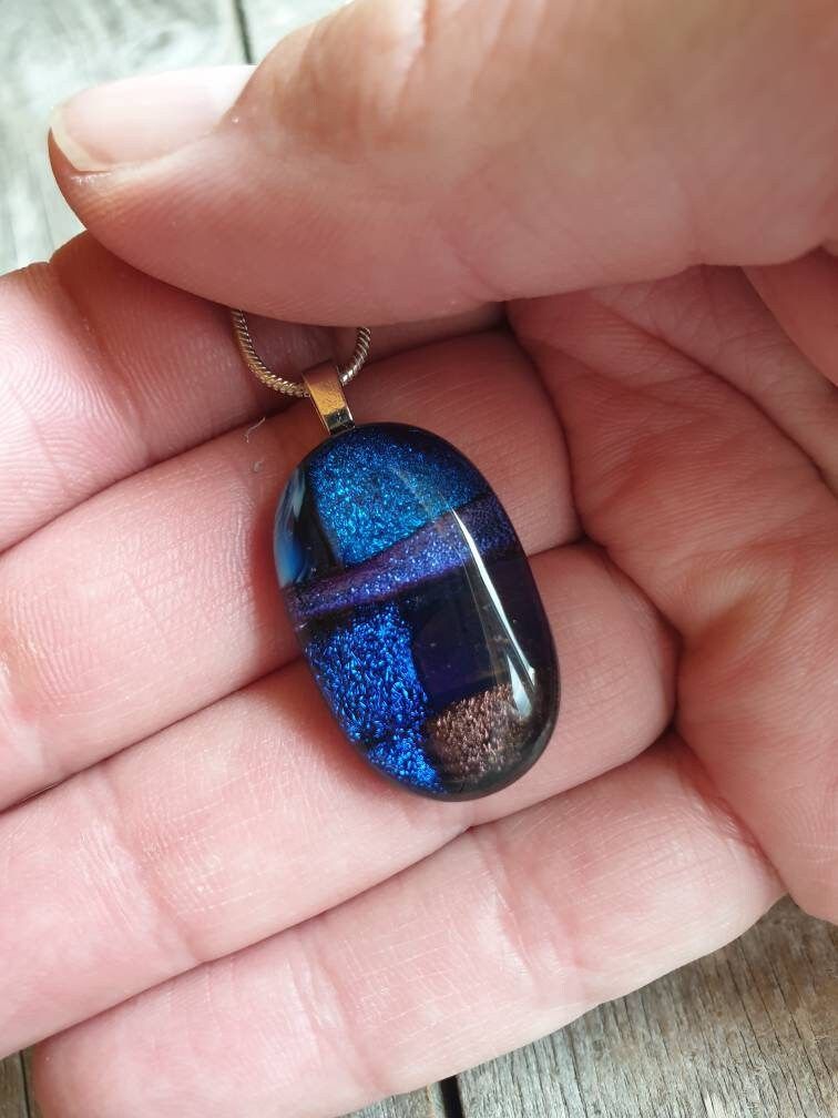 Beautiful sparkling blues and purples within this handcrafted dichroic glass necklace. #handmade #etsy #shopindie #etsy #giftideas buff.ly/4aXLXmC