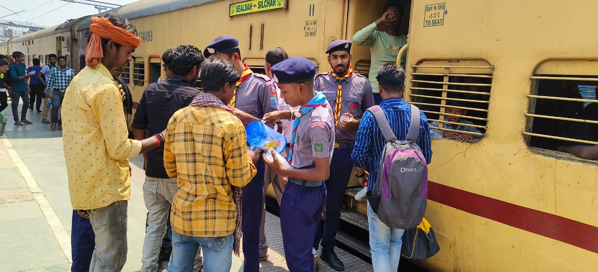 Scouts & Guides volunteered to distribute drinking water to passengers at Malda Town station, West Bengal providing relief from scorching summer heat.