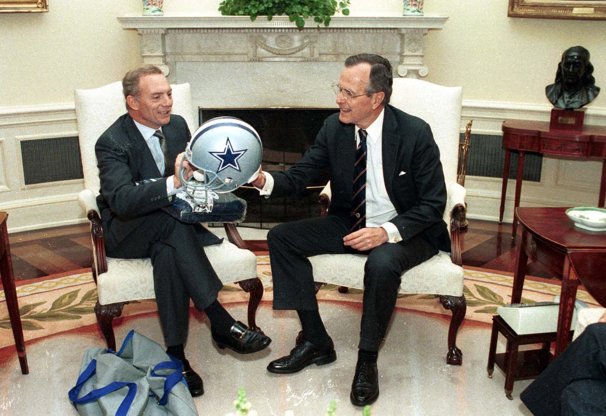 President Bush receives a Dallas Cowboys jacket and helmet from Jerry Jones, owner, in the Oval Office of the White House. April 5, 1989 Photo Credit: George Bush Presidential Library and Museum #bush41 #bush41library #bush41museum