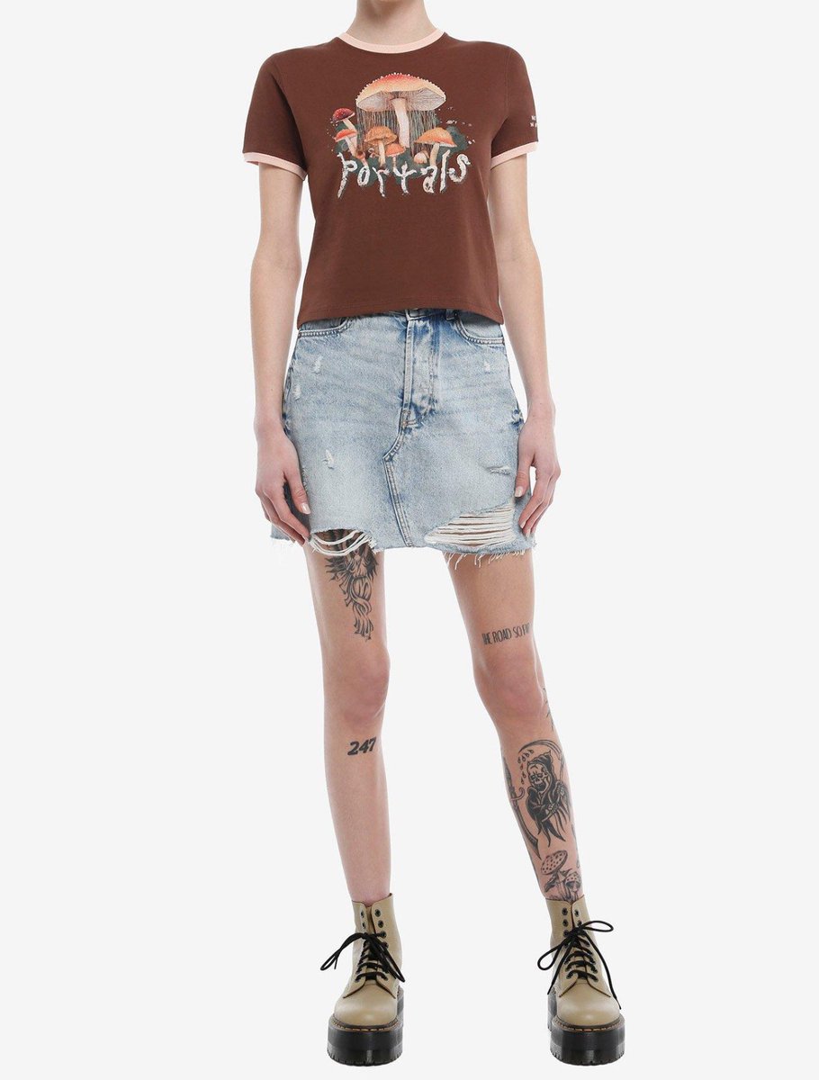 New Portals mushroom baby ringer t-shirt is now available for purchase on Hot Topic’s website 💕🍄‍🟫