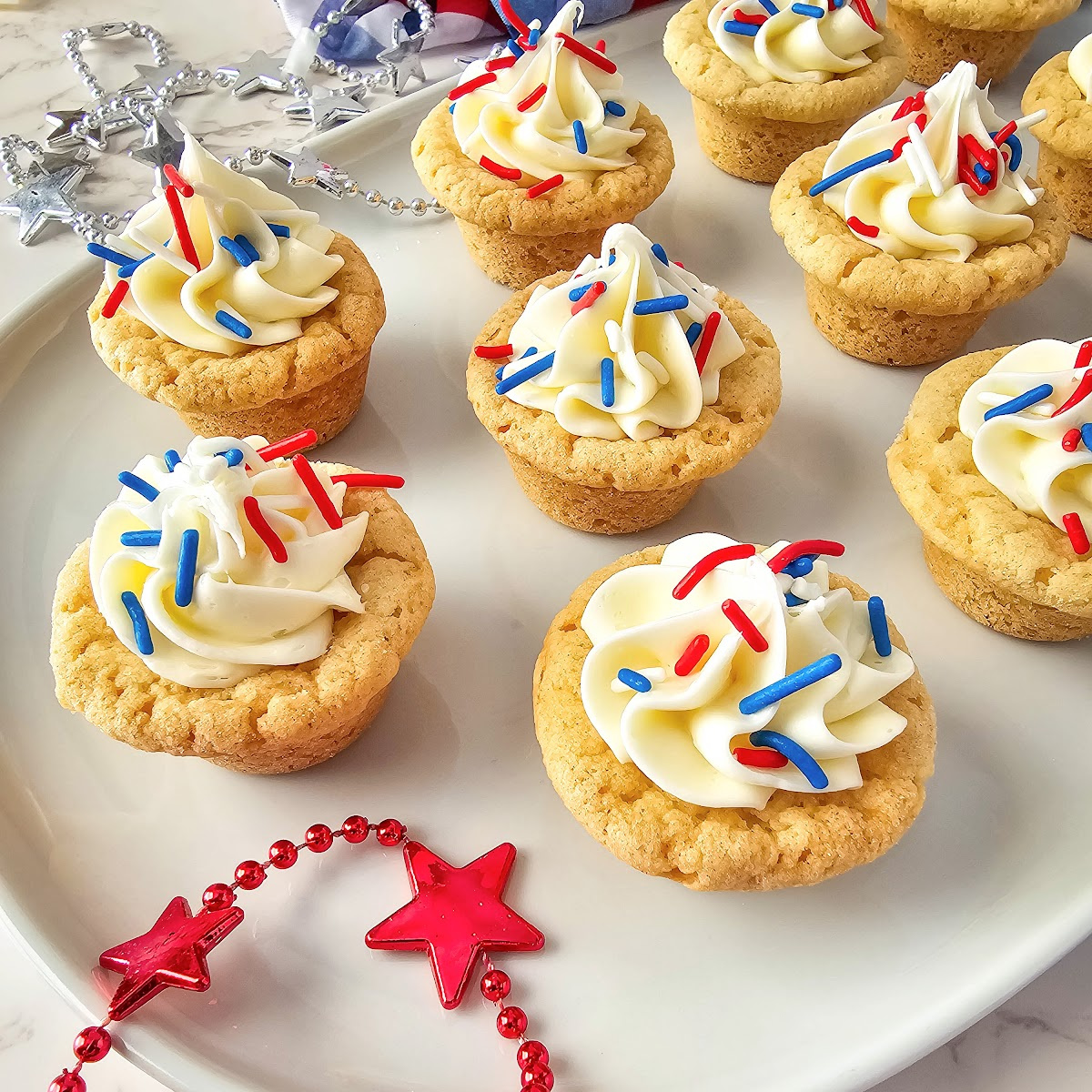 These easy-to-make bite sized Patriotic Sugar Cookie Cups are topped with festive red, white, and blue sprinkles. #patriotic #redwhiteandblue #cookies  blogghetti.com/patriotic-cook…