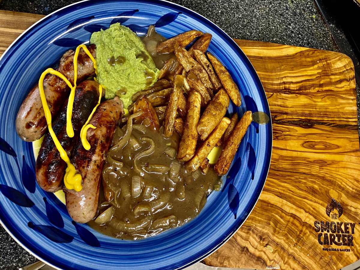 Simple or not simple? Sausages from The Ploughman's Farm Shop served up with homemade chips,homemade pea purée, homemade onion gravy, bit of mustard. Blooming lovely. #bbqlife #bbqsausage #chips #peapuree #thesmokeycarter