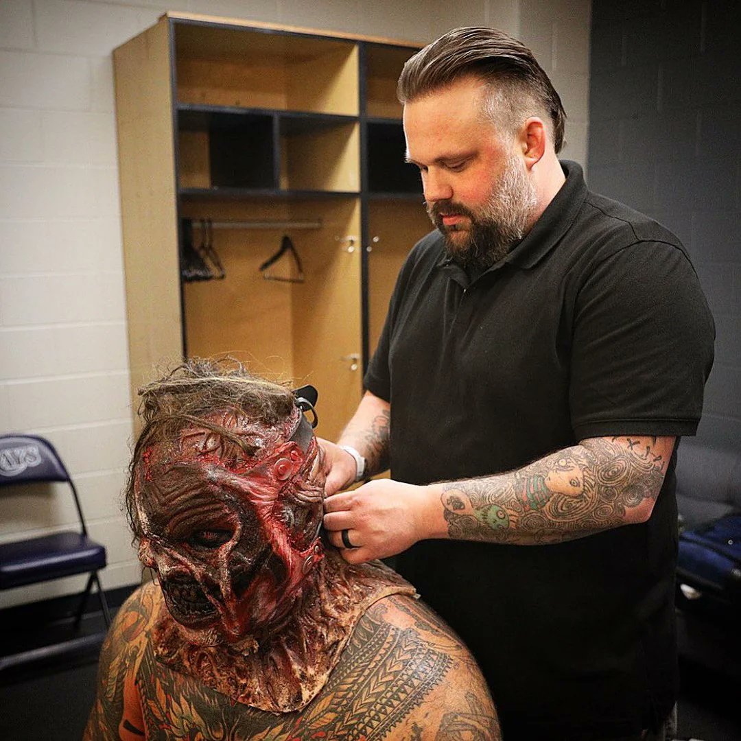 Bray Wyatt backstage with Jason Baker trying on the burnt version of The Fiend’s mask