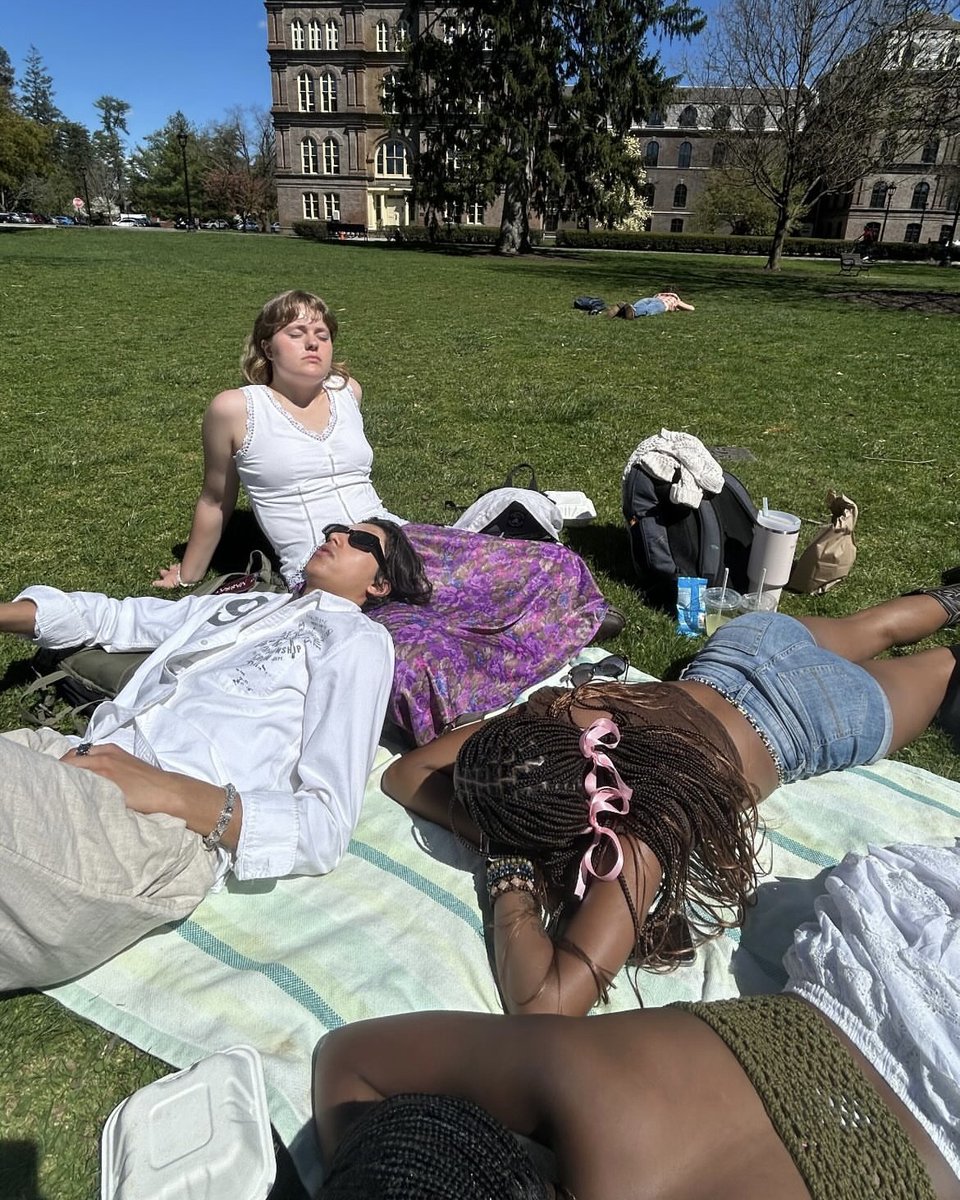 Vassar's tweet photo. Nothing beats a nap followed by a game of cards under blue skies! (Post by Jayda Taylor ‘27) #LibraryLawn https://t.co/8T8USsa5C4